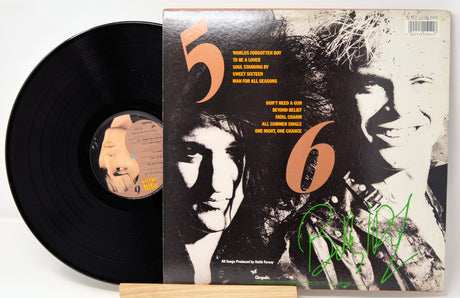 Vinyl record with a cover featuring two faces and the number '56'.