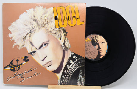 Vinyl record with a cover featuring a person with blonde hair and the title 'Whiplash Smile' by Billy Idol.