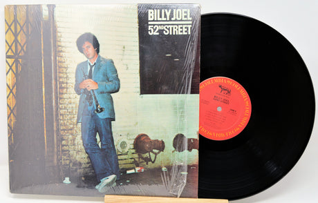 Vinyl record with '52nd Street' album cover featuring a person in a suit.