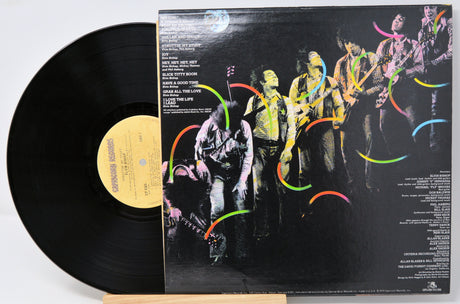 Vinyl record by Elvin Bishop called Struttin My Stuff and an image of the back cover containing text with song titles and credits.