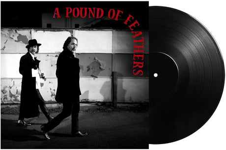 Vinyl record with 'A Pound of Feathers' text and black and white photo of two people walking.