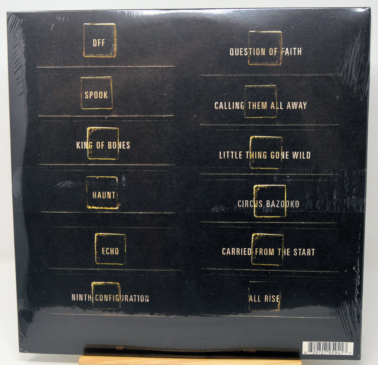 Back cover of a vinyl record with gold text on a black background