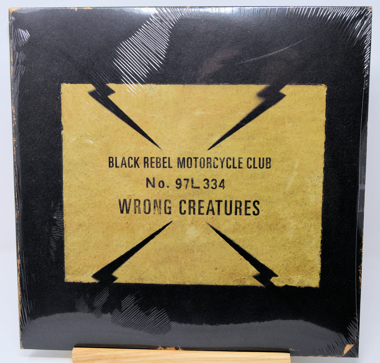 Vinyl record cover for 'Wrong Creatures' by Black Rebel Motorcycle Club with black and gold design.