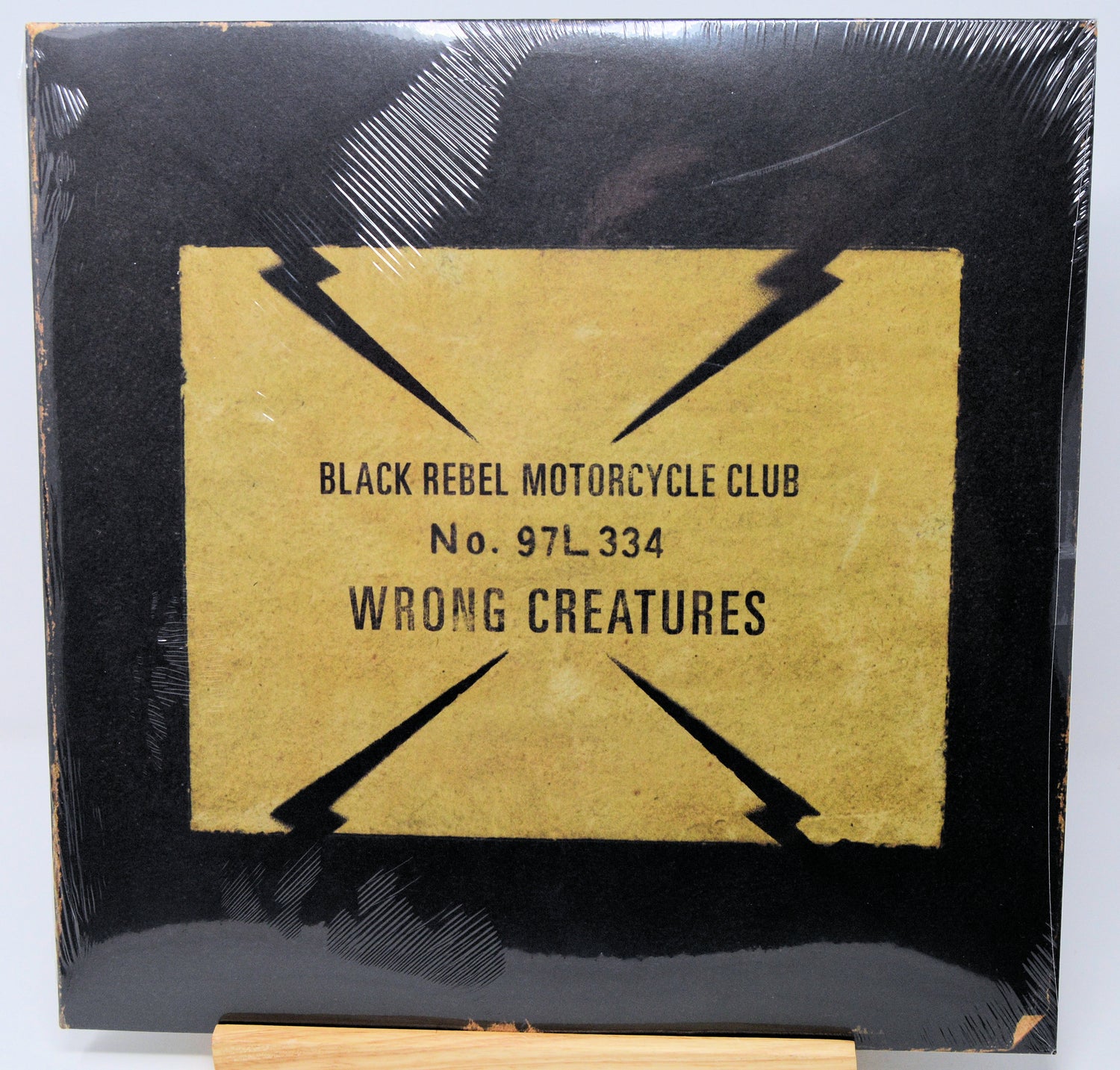 Vinyl record cover for 'Wrong Creatures' by Black Rebel Motorcycle Club with black and gold design.