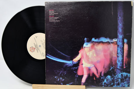Vinyl record with a colorful album cover featuring a person and abstract elements.