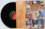 Vinyl record with a colorful album cover featuring a tiger and various images.