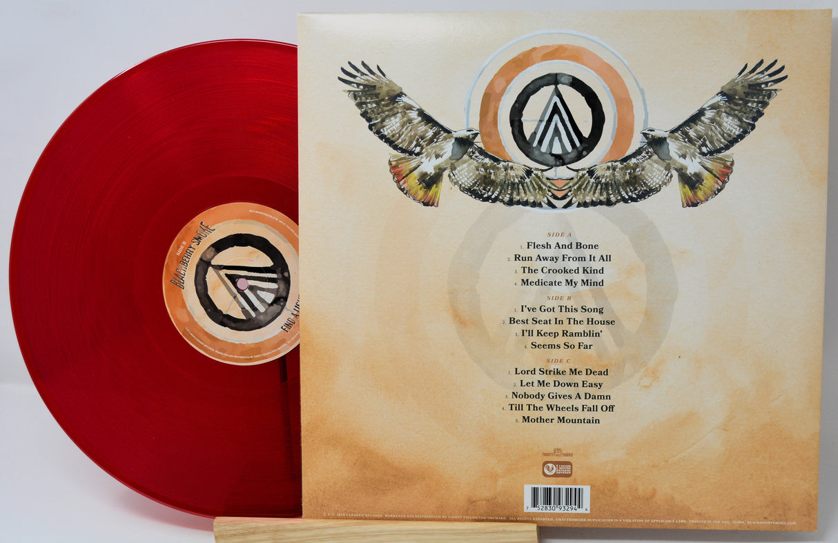 A vinyl record album shown with the red record partially pulled from the sleeve, which displays the back cover artwork featuring an eagle and track list. The record label shows the stylized 'A' logo of Arch Enemy.