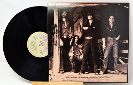 Vinyl record with a black and white photo of four people on the cover