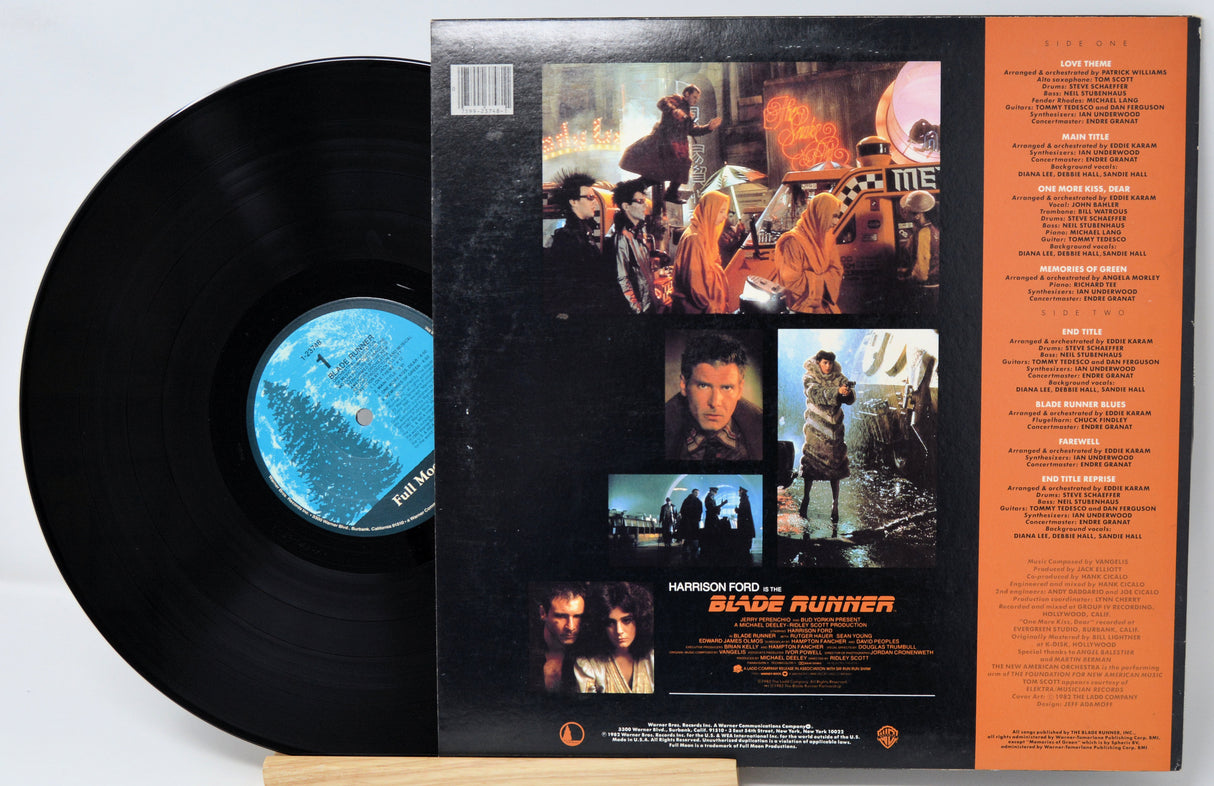 Vinyl record with 'Blade Runner' cover featuring images and text.