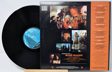 Vinyl record with 'Blade Runner' cover featuring images and text.