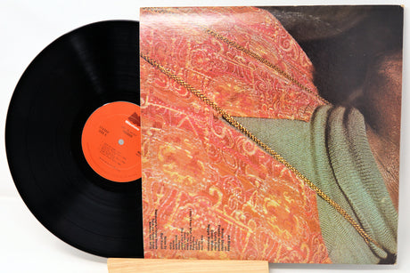 Vinyl record with a colorful cover featuring a pattern and text.