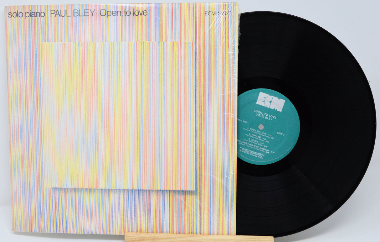 Vinyl record with cover displaying 'Open to Love' by Paul Bley on a light gray background