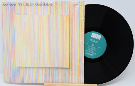 Vinyl record with cover displaying 'Open to Love' by Paul Bley on a light gray background