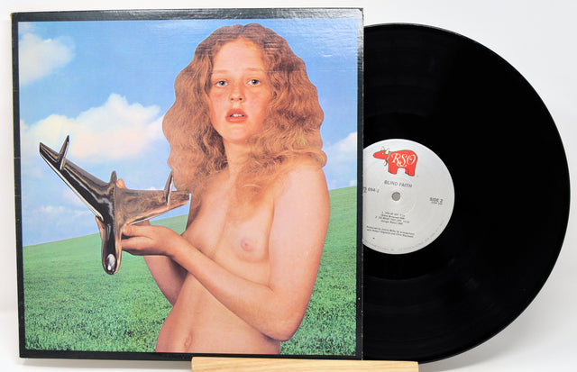 Vinyl record with a cover featuring a stylized depiction of a person holding a tool, set against a blue sky and green field.