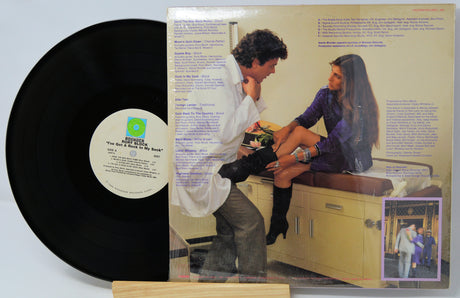 Vinyl record with a cover featuring a couple and text