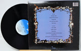 Vinyl record with a decorative cover featuring text and floral designs.