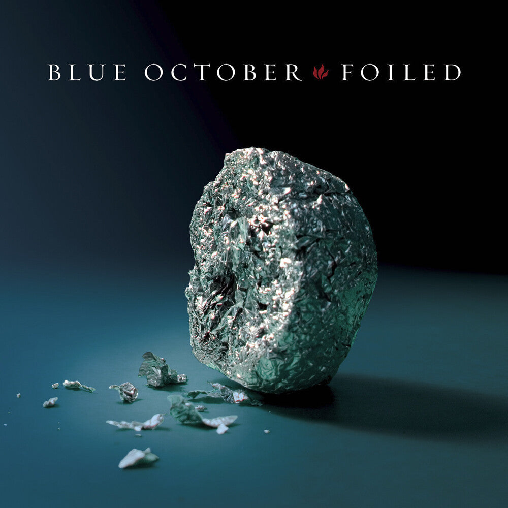 Album cover with a mineral-like rock and 'Blue October Foiled' text on a gradient background