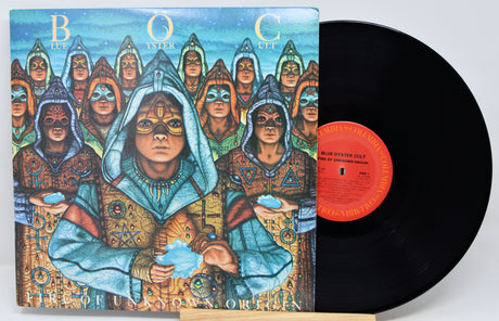 A vinyl record album with its illustrated cover jacket shown beside the black record. The cover art features a stylized group of hooded figures in ornate robes against a blue sky, with the title text 'Blue Oyster Cult' and 'The Holy Oyster' visible.
