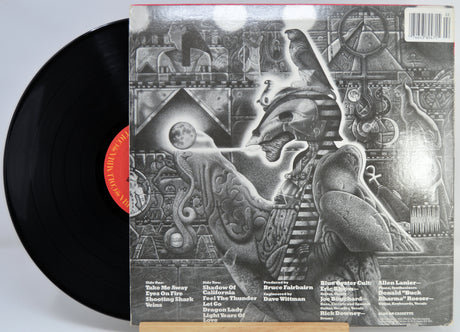 Blue Oyster Cult - Revolution By Night Vinyl record with a detailed back cover featuring artistic design and text.