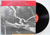 Vinyl record with 'Blue Öyster Cult' album cover showing a red label and black and white design.