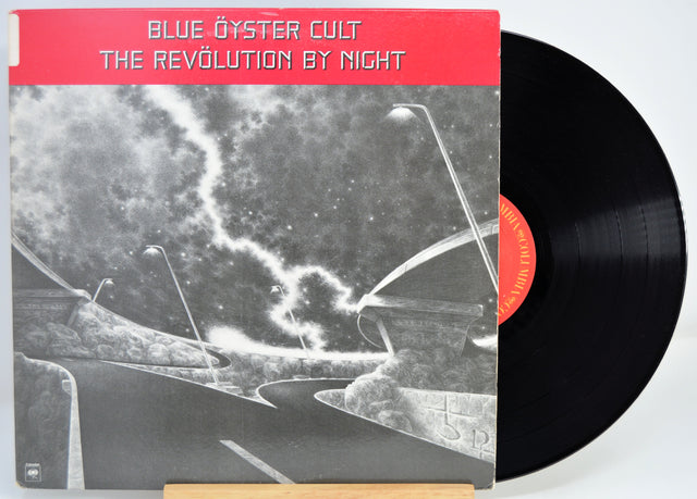 Vinyl record with 'Blue Öyster Cult' album cover showing a red label and black and white design.