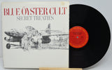 Blue Oyster Cult's 'Secret Treaties' vinyl record album, showing the illustrated white cover with red title text and a black LP partially pulled out, with a red center label.