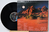 Vinyl record with a desert landscape design on the cover