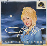 Front cover of Dolly Parton's Home / Blue Smoke vinyl featuring an illustrated portrait of Dolly Parton and a Record Store Day sticker