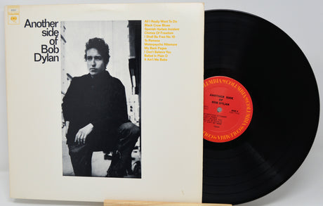 Vinyl record and cover featuring Bob Dylan with a black and white photo and red label.