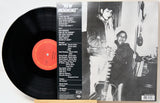 Vinyl record album 'New Morning' with the black LP partially pulled from the sleeve, showing the tracklist on the back of the cover and a black-and-white photo of two people holding guitars.