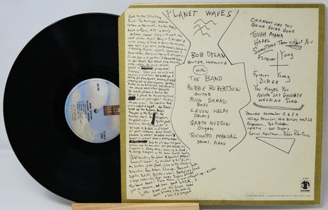 Vinyl record with 'Planet Waves' by Bob Dylan and The Band, featuring a detailed liner note sleeve.