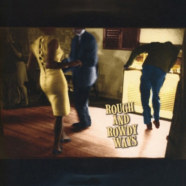 Album cover for Rough and Rowdy Ways, featuring a dimly lit scene of three people in a room with warm yellow lighting. The title 'ROUGH AND ROWDY WAYS' is written in bold, stylized text in the lower right.