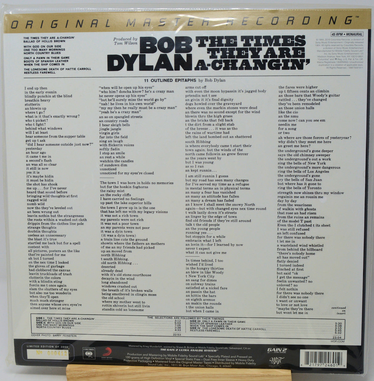 Back cover of a Bob Dylan vinyl record showing the track listing for '11 Outlined Epigrams: They Are Dylan a Changelin', with the Bob Dylan name in large black text and a gold 'Original Master Recording' banner at the top.