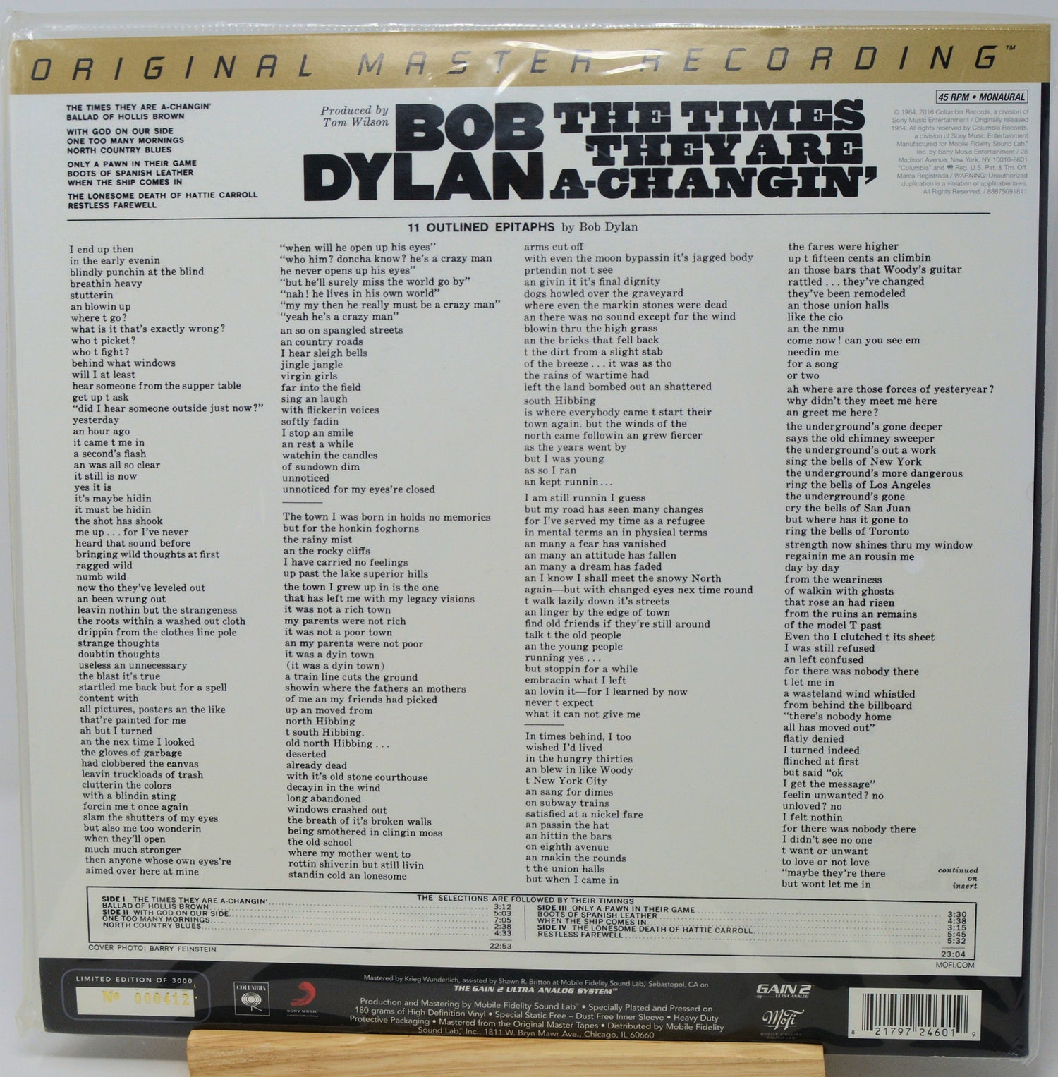 Back cover of a Bob Dylan vinyl record showing the track listing for '11 Outlined Epigrams: They Are Dylan a Changelin', with the Bob Dylan name in large black text and a gold 'Original Master Recording' banner at the top.