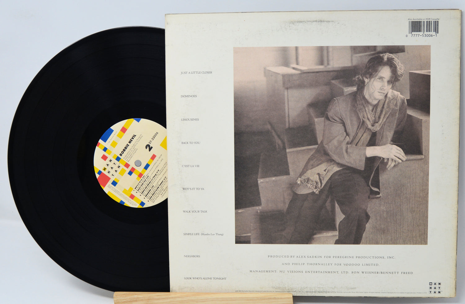 Vinyl record with a black label and a photo of a person on the cover