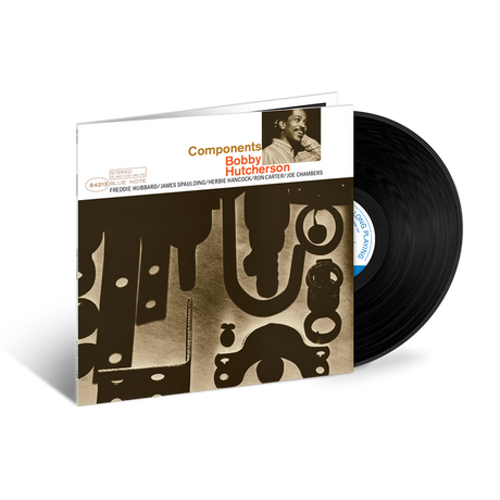 Vinyl record with a cover featuring a stylized design and a portrait of a person.