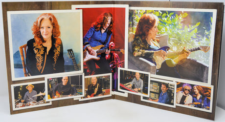 A custom photo collage print displayed on a wooden backing, featuring multiple color photographs of a woman playing guitar and portraits of musicians, arranged in a fan-like layout.
