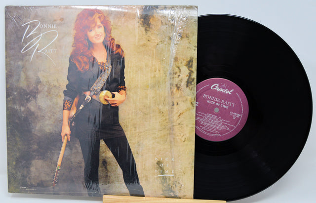 Vinyl record with orange cover featuring a silhouette of a couple and text 'Emotions'.