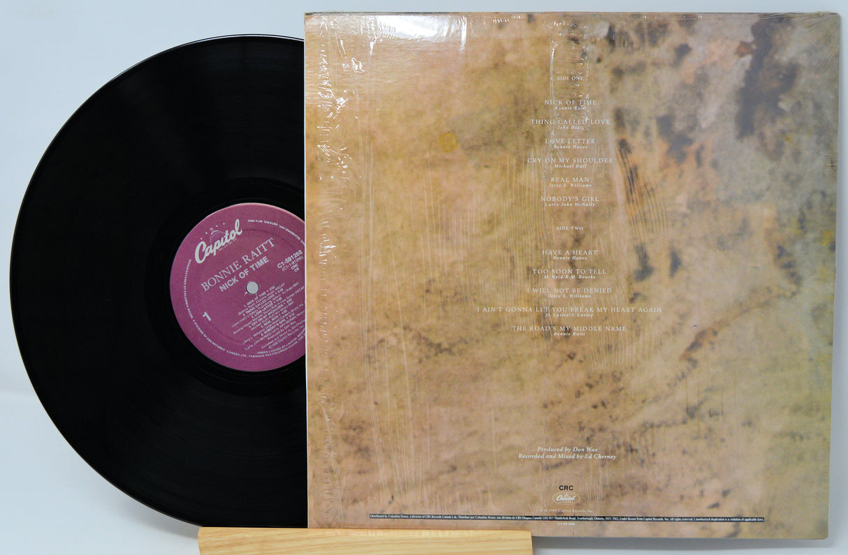 Vinyl record with a textured cover and visible label on a light gray background