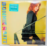 Bonnie Raitt's 'Slipstream' 2-CD box set vinyl record cover, sealed in plastic shrink wrap, displayed on a wooden stand against a white background.