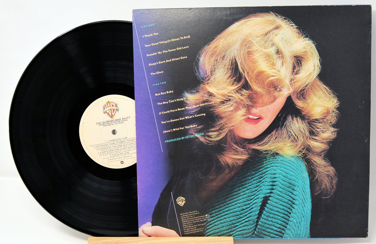 Vinyl record with cover featuring a woman's face and album details.