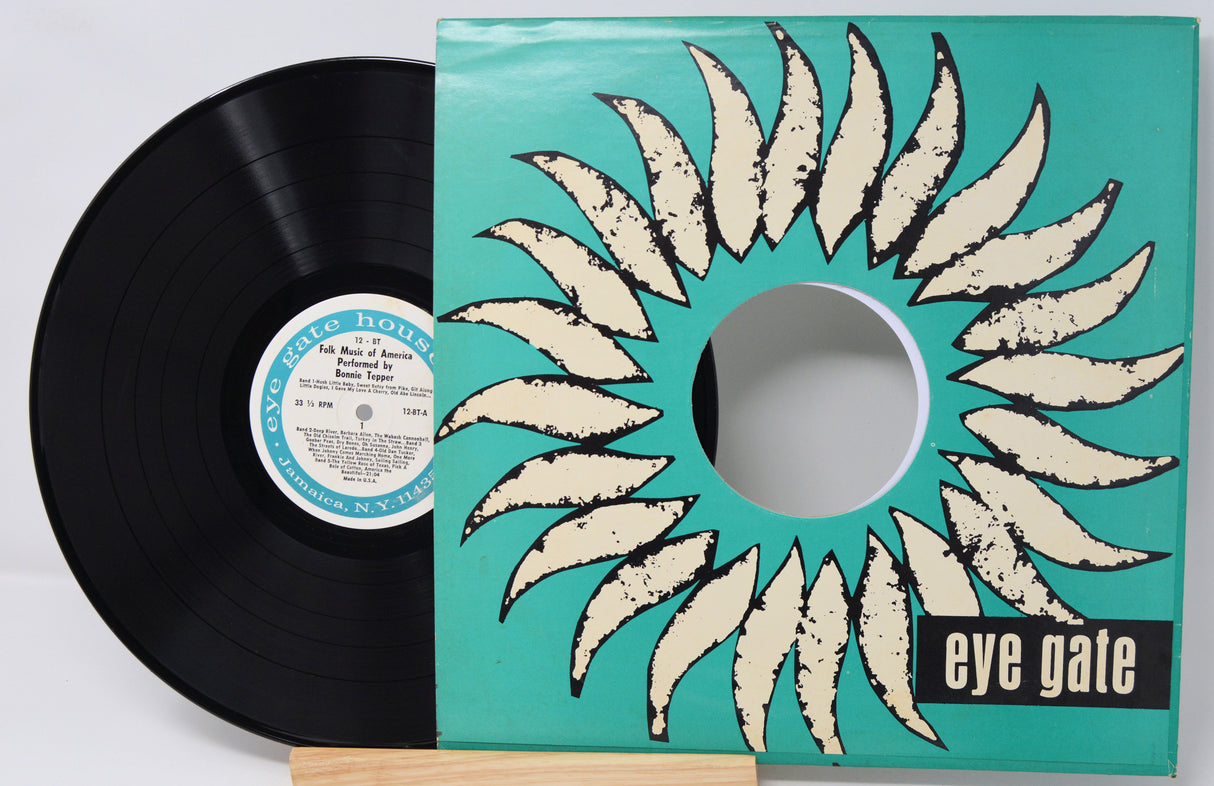 Vinyl record with a unique sleeve design featuring a sun-like pattern and 'eye gate' branding.