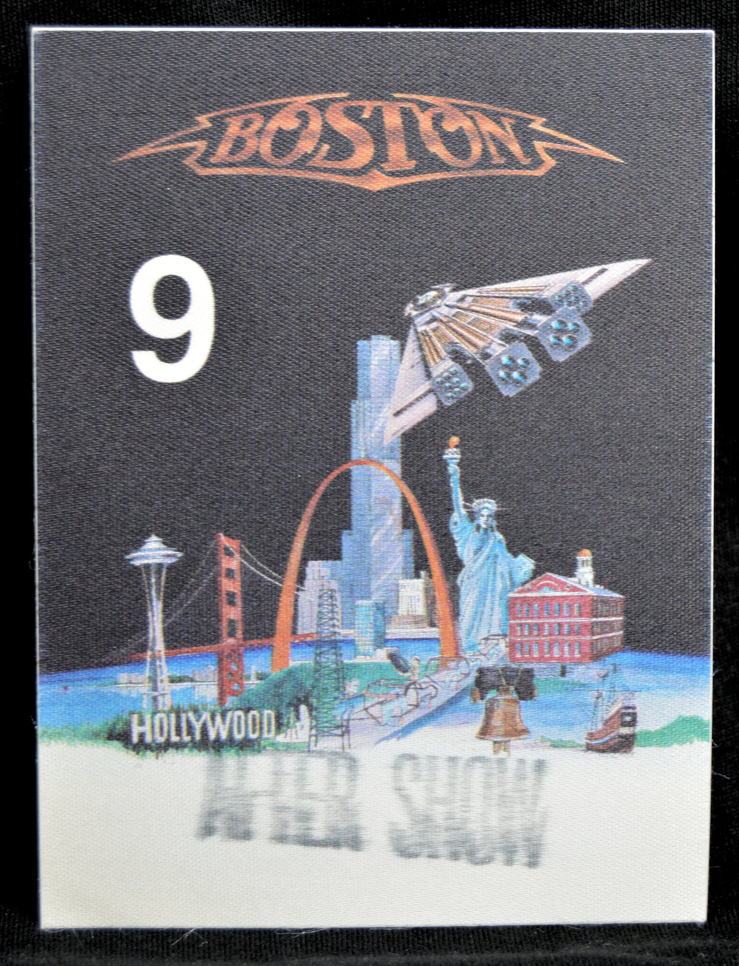Backstage pass with 'Boston' logo, number 9, and cityscape illustration on a black border.