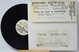 Vinyl record with a white label and a cardboard sleeve displaying text about the album 'Boston Alive!'.