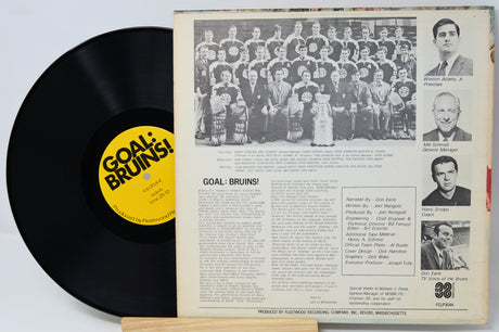 Vinyl record with a yellow label and a photo sleeve featuring a group of people.