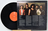 Vinyl record with a black cover featuring a band's portrait and tracklist.