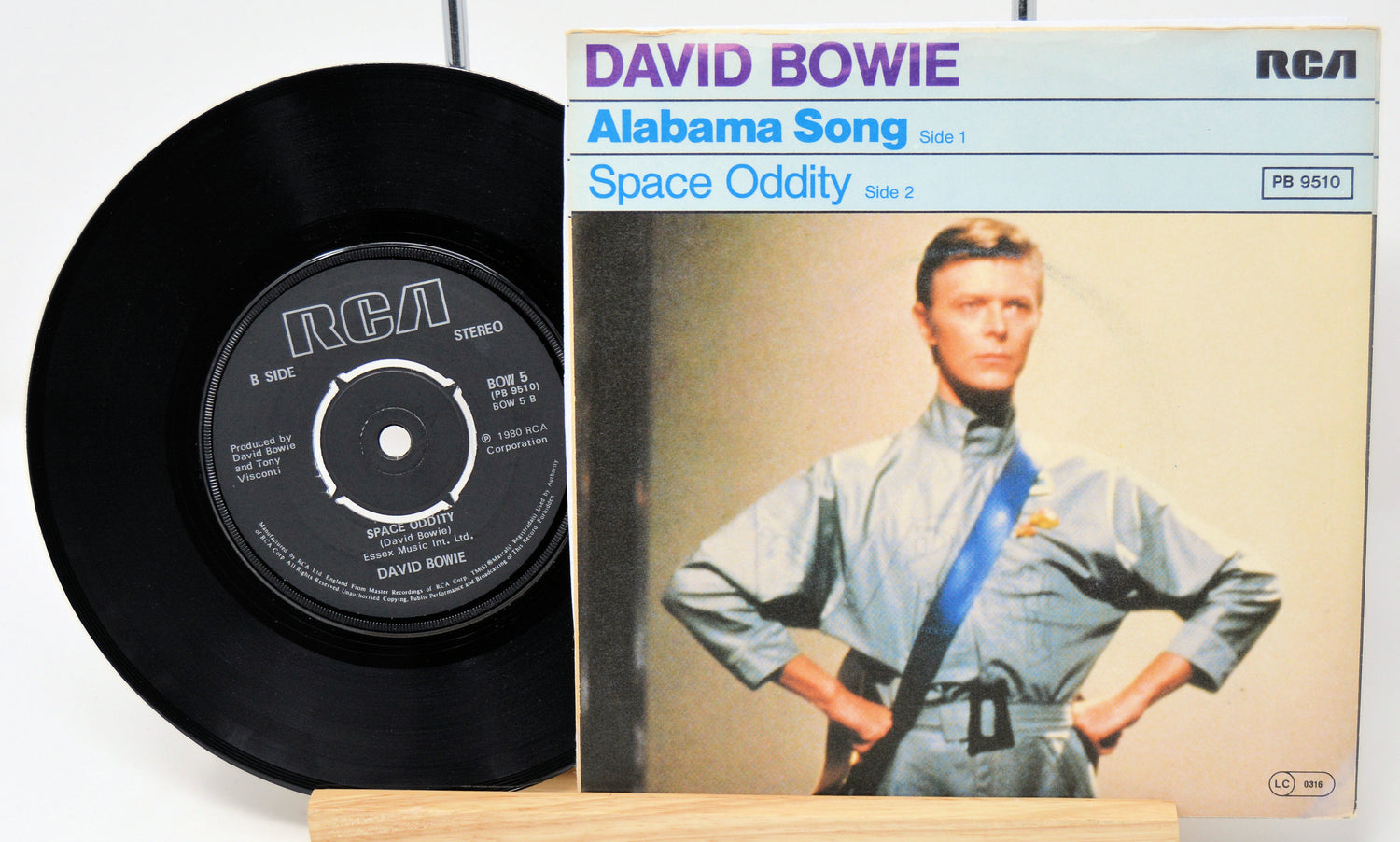 Vinyl record and cover of 'Space Oddity' by David Bowie on a white background