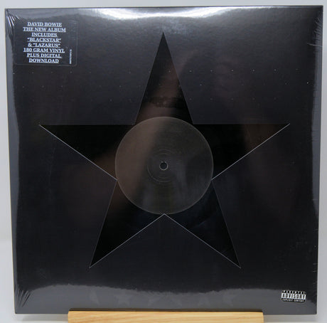 Black vinyl record with star design on the cover, featuring text about David Bowie's album.