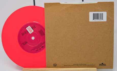 Red vinyl record with a brown sleeve on a white background