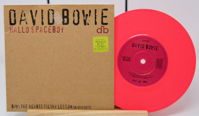 Vinyl record with red disc and brown cover featuring 'David Bowie Hallo Spaceboy' on a white background